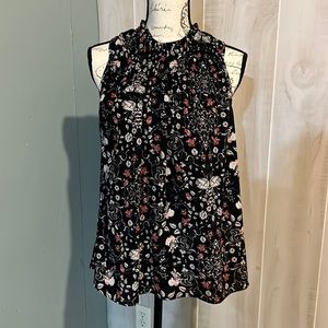 High neck sleeveless blouse.